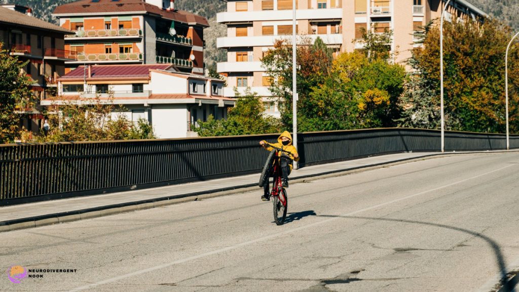 boy doing a wheelie on a road in a yellow jacket.